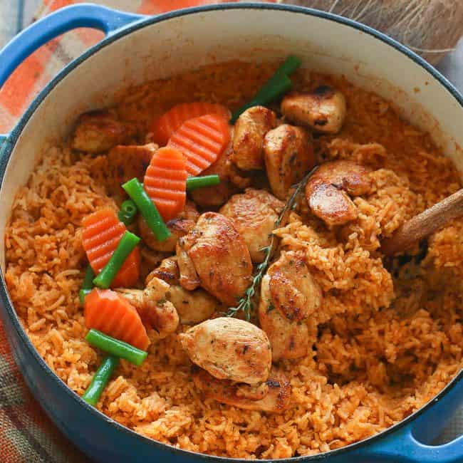 Coconut Jollof in a pot with carrots and green beans