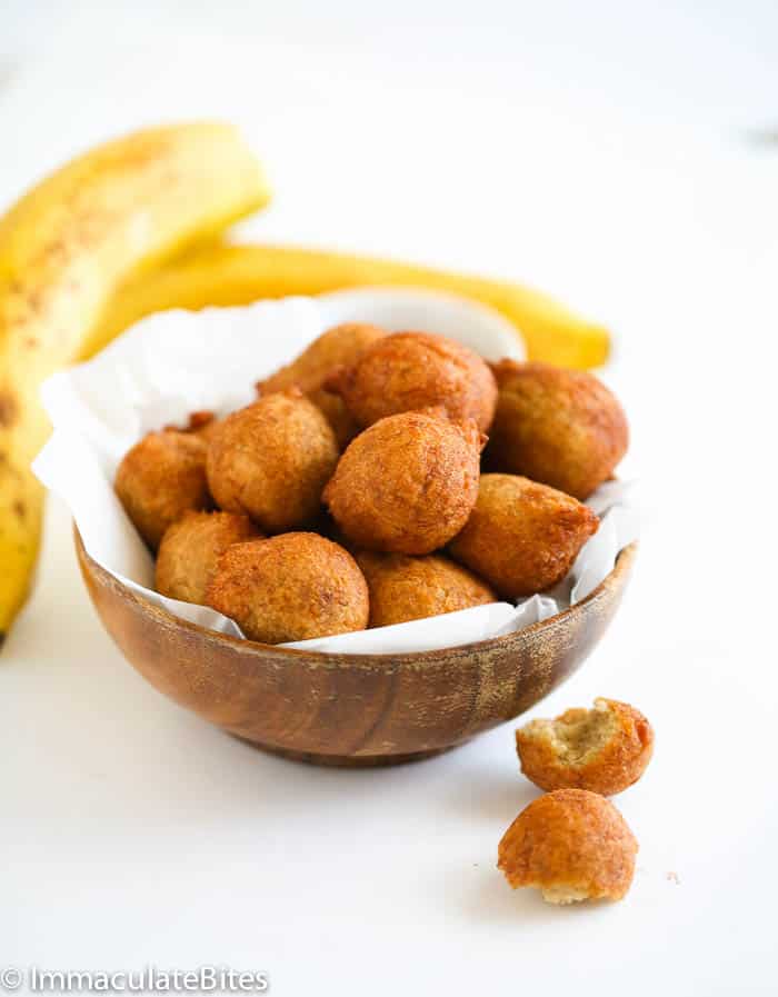 Homemade whole wheat accra banana with fresh bananas in the background for African comfort food