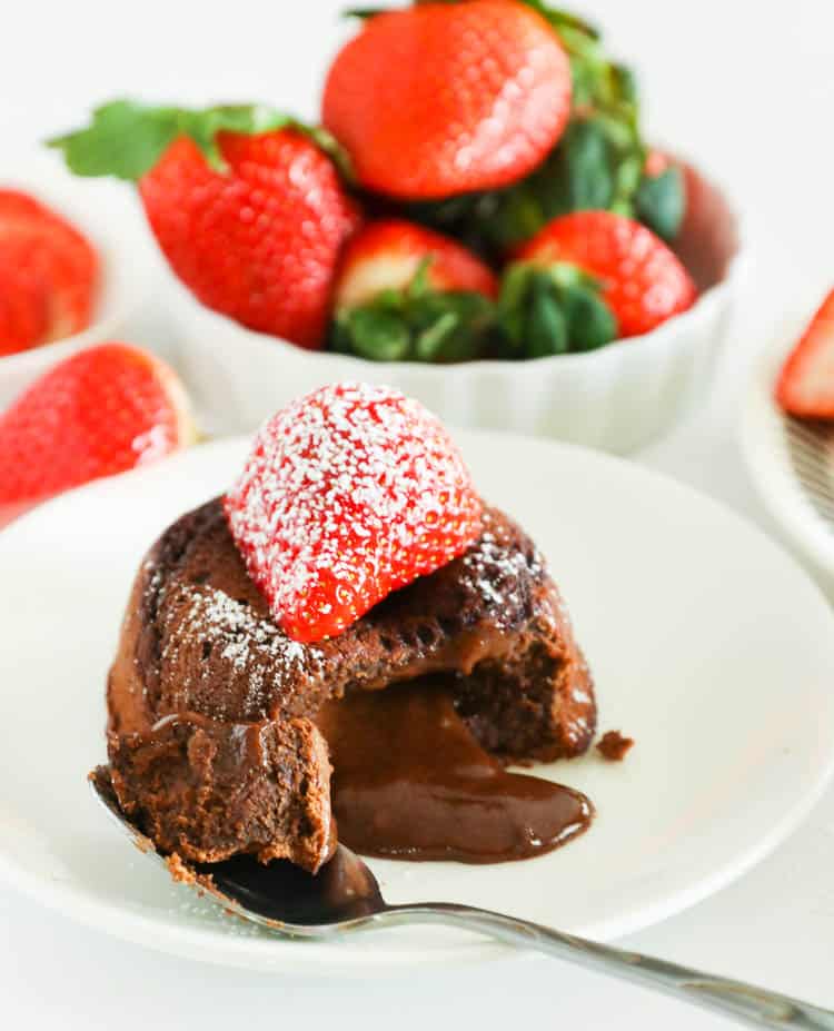 Sliced Chocolate Lava Cake topped with a Strawberry