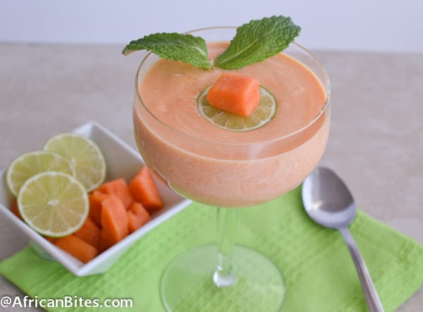An insanely delicious and refreshing papaya fool with chunks of fresh papaya, lime slices and mint leaves