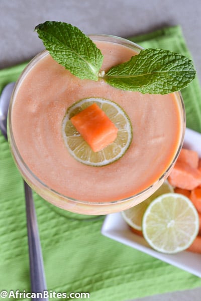 A refreshing papaya fool decorated with a papaya cube and mint leaves