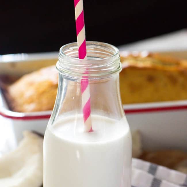 Enjoying a refreshing glass of coconut milk made from fresh coconut.