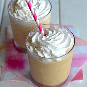Sticking a straw in two energizing blended Thai ice coffees with homemade whipped cream