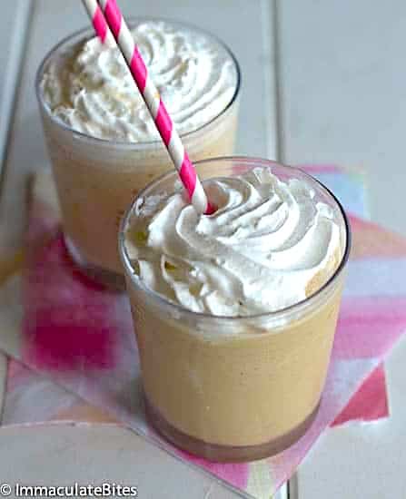 Sticking a straw in two energizing blended Thai ice coffees with homemade whipped cream