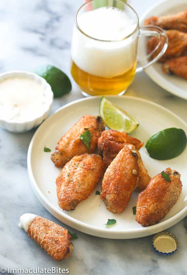 Enjoying crazy delicious baked crispy chicken wings with beer