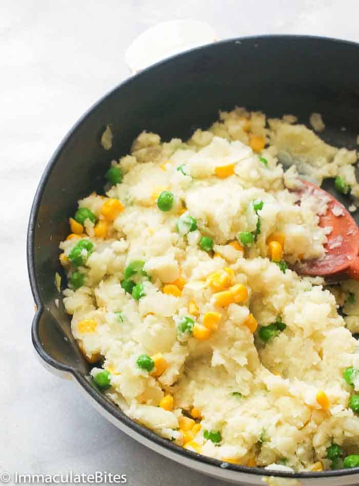 a pan of irio or mashed sweet potato with peas and corn