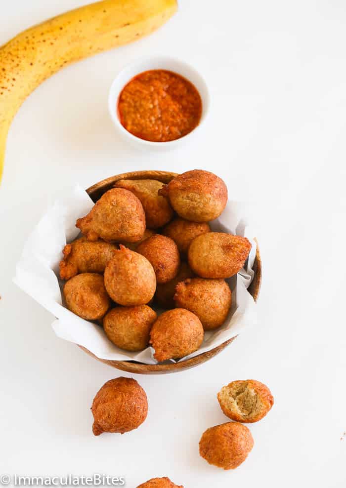 Enjoying freshly made whole wheat accra banana in a basket