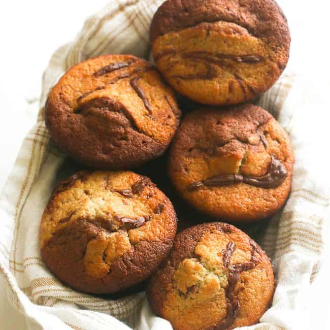 Banana chocolate coconut muffins on a kitchen towel