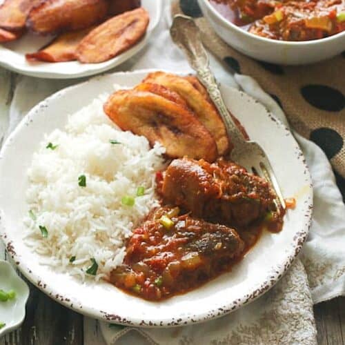 Serving up curry goat with rice and fried plantains.