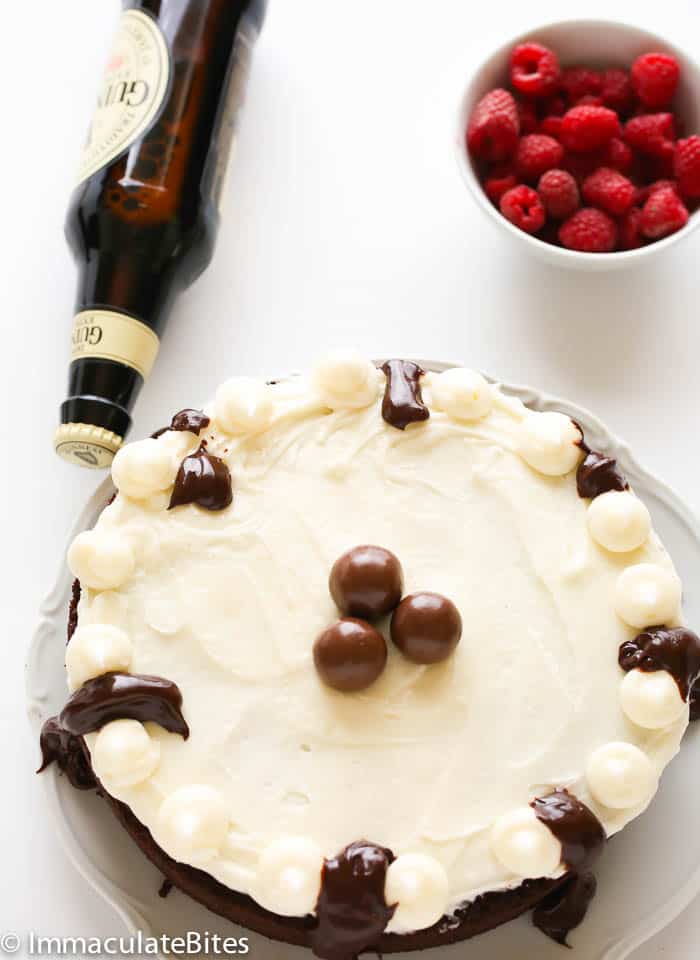 Guinness Chocolate Cake with raspberries and a bottle of beer for the perfect St. Patrick's Day recipe