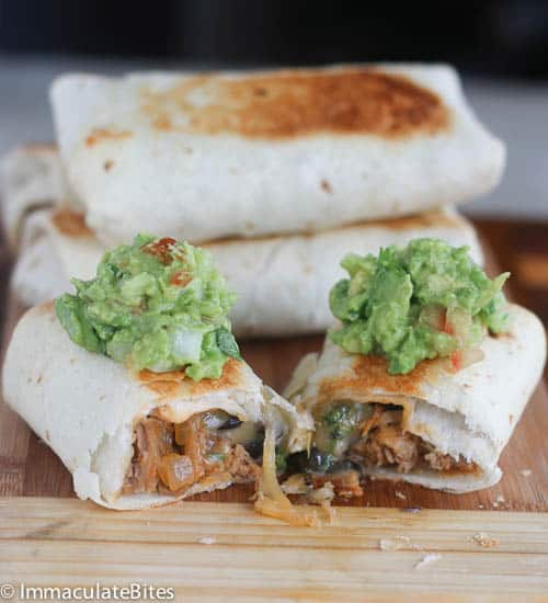Baked chimichangas with a dollop of guacamole for a healthy and delicious alternative