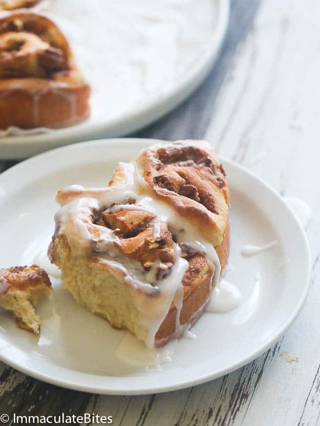 A decadent cinnamon bun on a plate ready to please