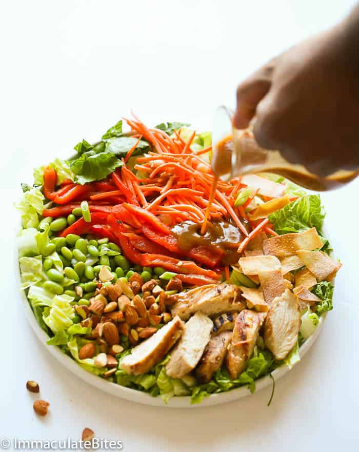 Drizzling an amazing Asian-inspired dressing over a healthy chicken salad