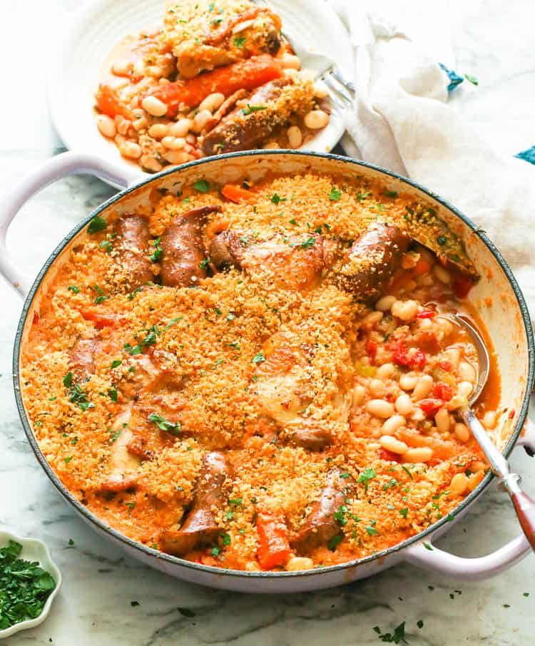 A pot of protein-rich cassoulet with a plate of it in the background