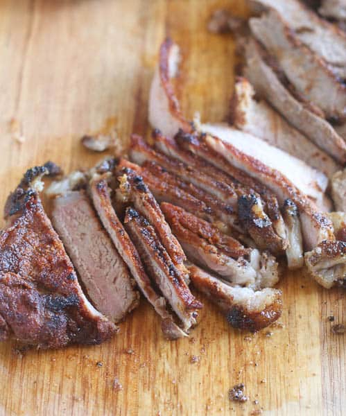 Slicing freshly grilled steak for an insanely good suya sandwich