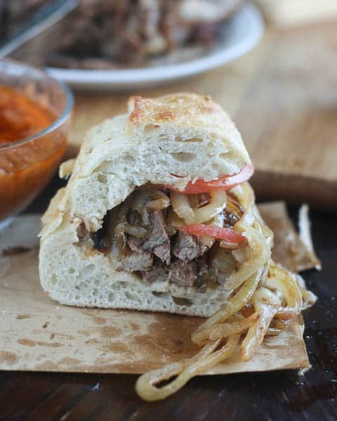 Cutting open a freshly made suya sandwich, and ready to take a big bite