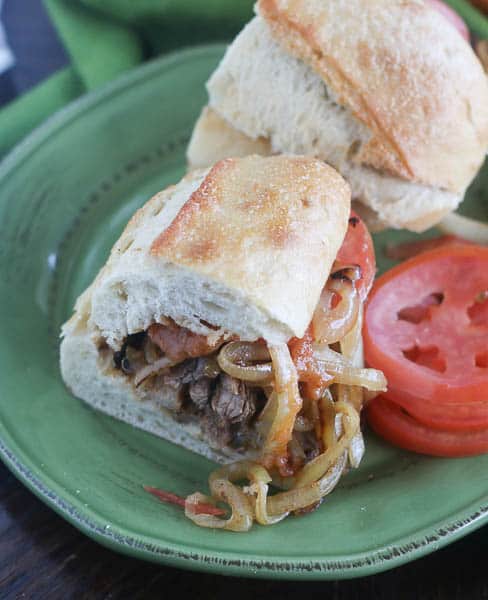 Diving into a warm suya sandwich with tomato slices