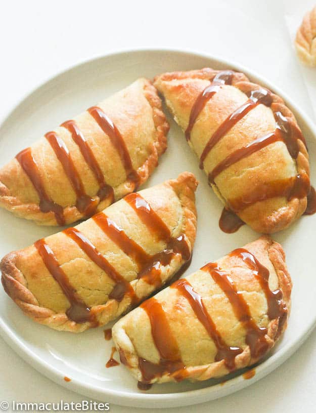 A plateful of decadent pineapple empanadas drizzled with caramel