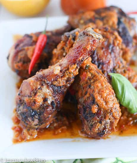 Delectably spicy piri piri chicken legs on a square white platter