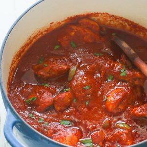 A freshly made pot of African chicken stew ready to serve over coconut rice