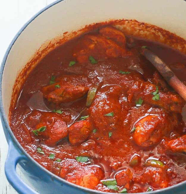 A freshly made pot of African chicken stew ready to serve over coconut rice