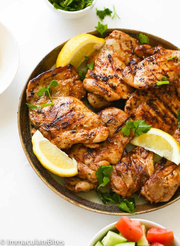 Tender and juicy grilled boneless chicken with lemon wedges