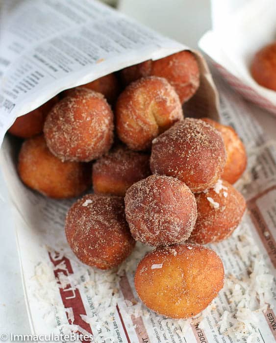 A fresh batch of koeksisters wrapped in newspaper for a traditional snack