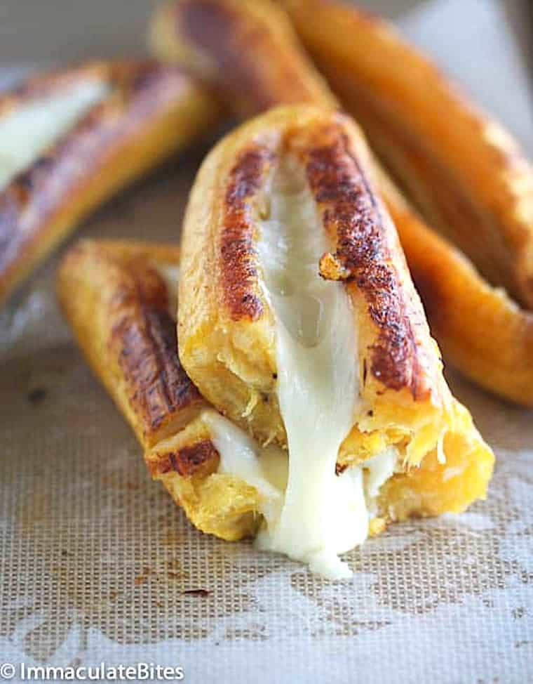 Breaking into a cheesy sweet baked plantain.