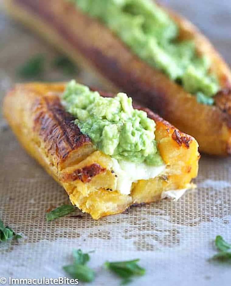 Diving into baked plantains filled with cheese and guac.