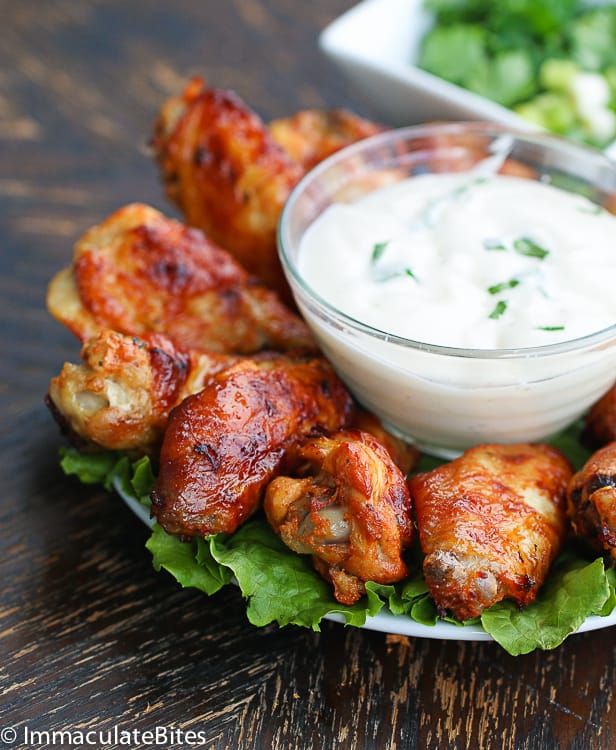 A platter full of delicious chicken wing shawarma with ranch dressing