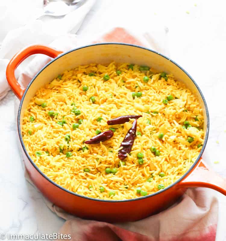 yellow rice with cayenne in red pan