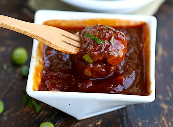 Dipping a freshly baked meatball into insanely tasty pineapple BBQ sauce