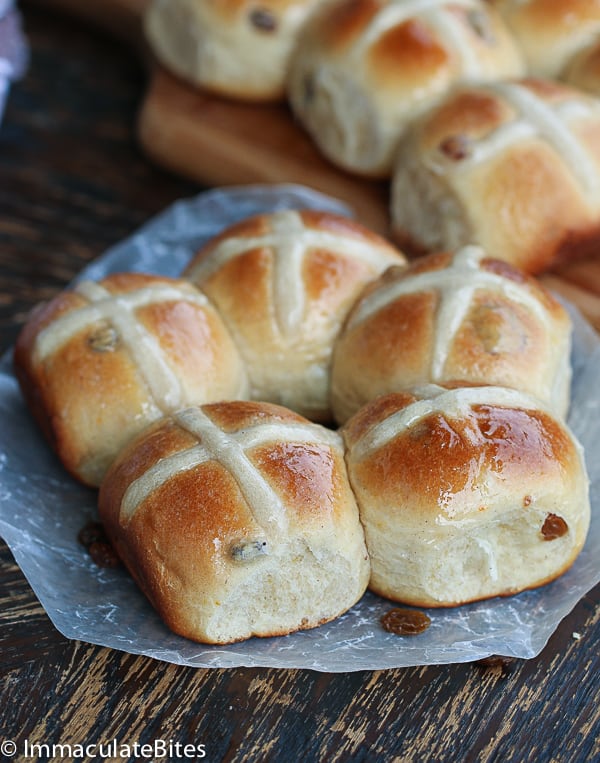 Buns with flour paste cross on parchment paper