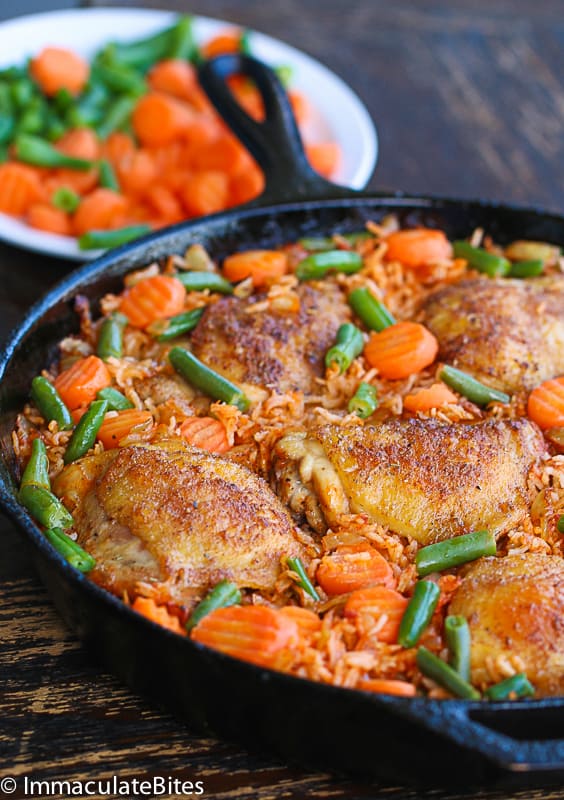 Jollof Rice and Chicken with Carrots and Beans in a Cast-Iron Pan