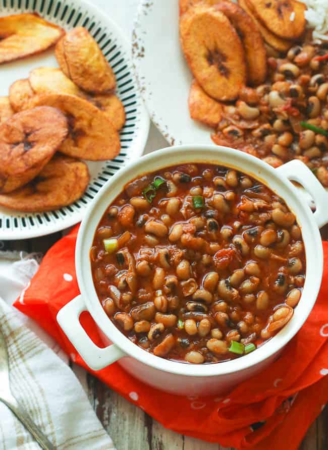 A bowl of red red served with fried plantains