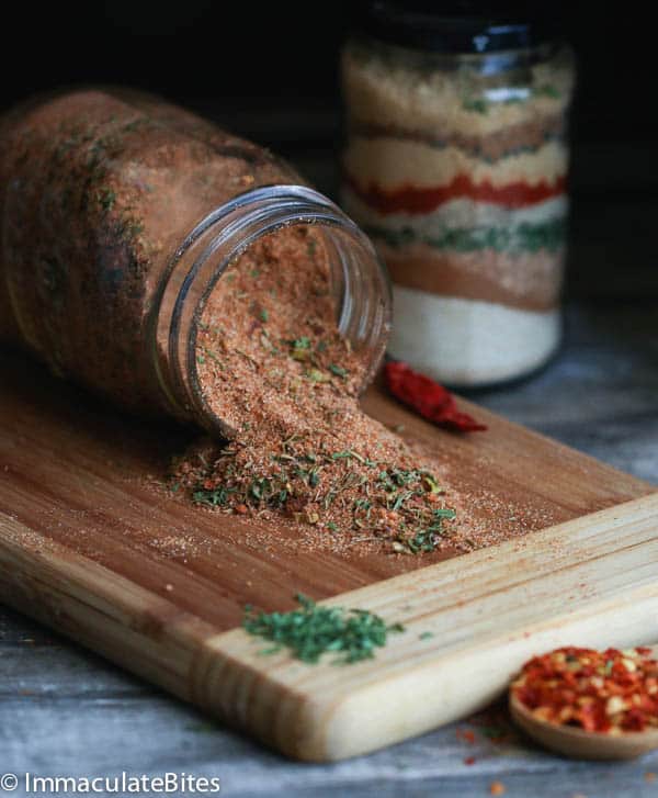 An Opened Bottle of Jamaican Jerk Seasoning on a Chopping Board