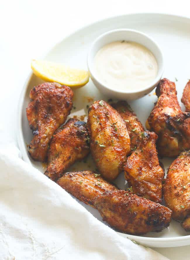 Enjoying a plateful of jerk wings with dipping sauce on Super Bowl Day