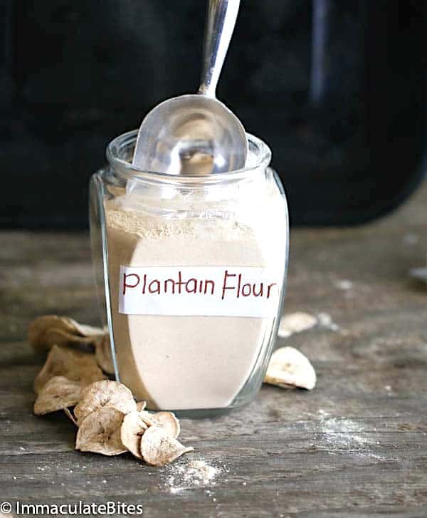 Scooping out a spoonful of homemade plantain flour