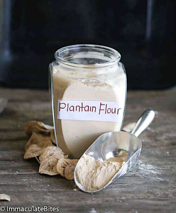 Scooping out homemade plantain flour from the jar