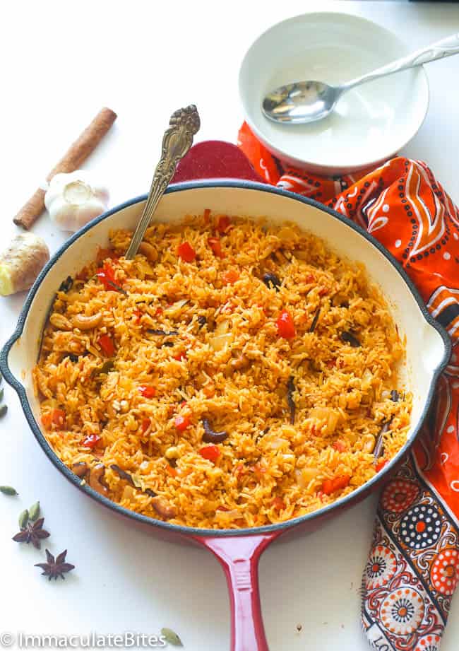 a pan of East African Pelau Rice with an empty bowl and spoon in the background