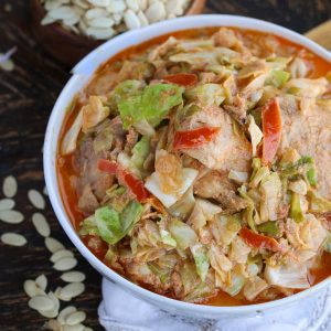 Serving up an insanely delicious bowl of cabbage egusi soup with white melon seeds in the background