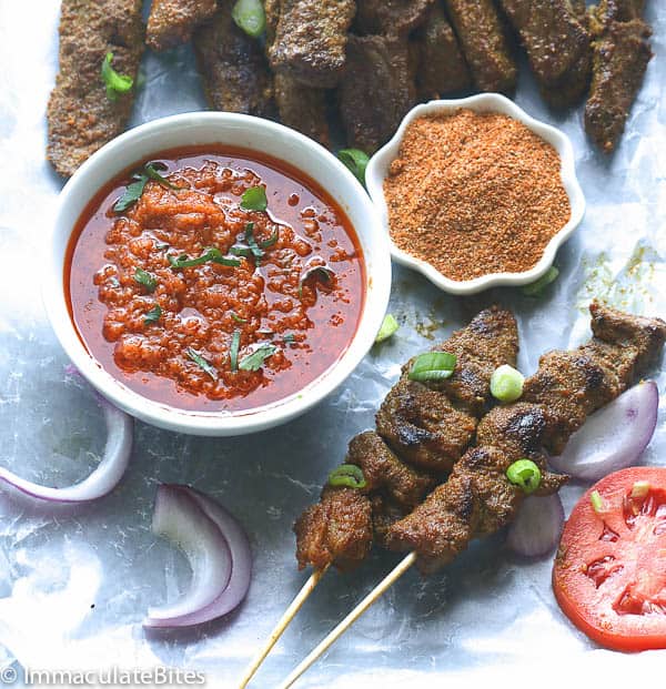 Curry Beef Satay served with sauce on a sheet pan