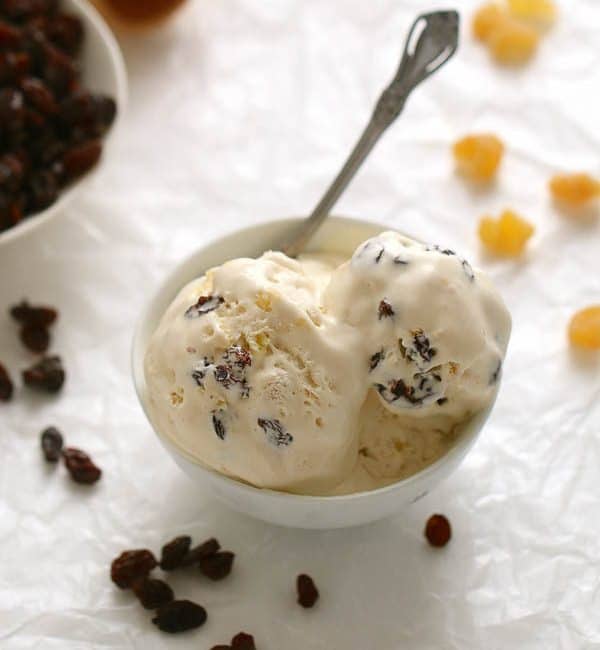 Rum raisin pineapple ice cream in a bowl with a spoon