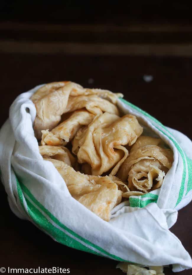 Serving up a basket full of paratha buss up shut for Trinidad comfort food