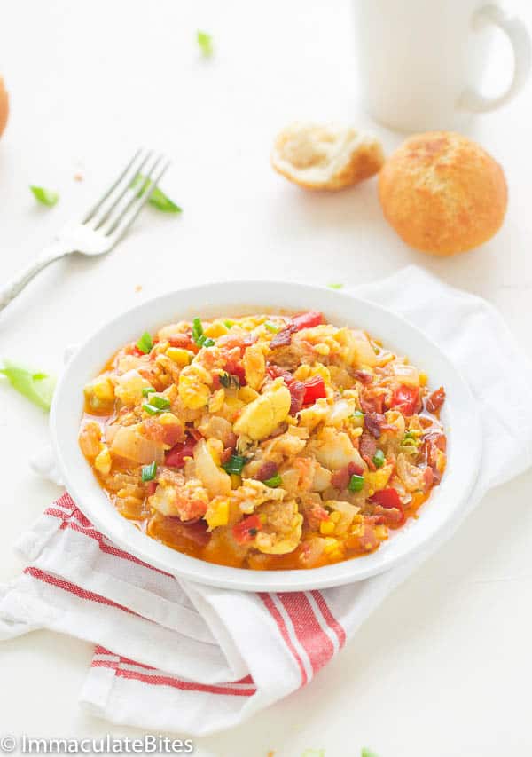 Jamaican ackee and Saltfish in a white bowl with homemade fritters