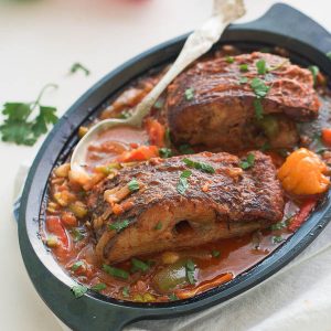 Caribbean Fish Stew with hot peppers in the background