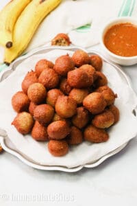 A plateful of banana fritters with sauce