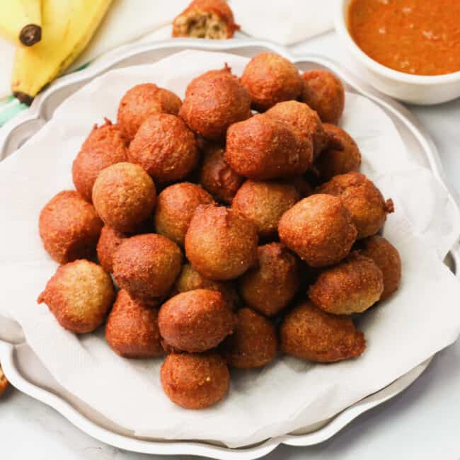 A plateful of banana fritters with sauce