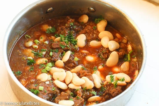 Adding butter beans to the stew