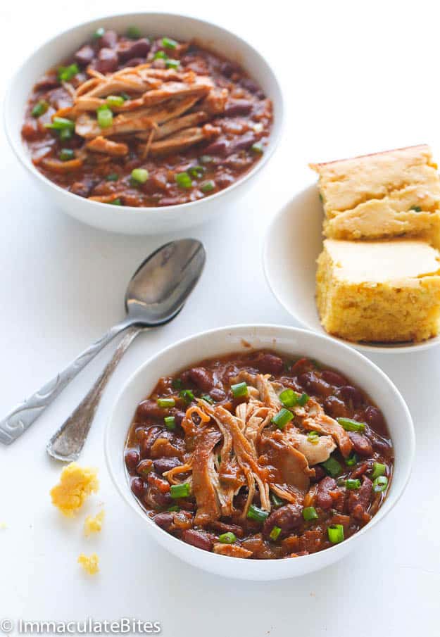 Serving up two delicious bowls of slow cooker chicken stew with beans and cornbread